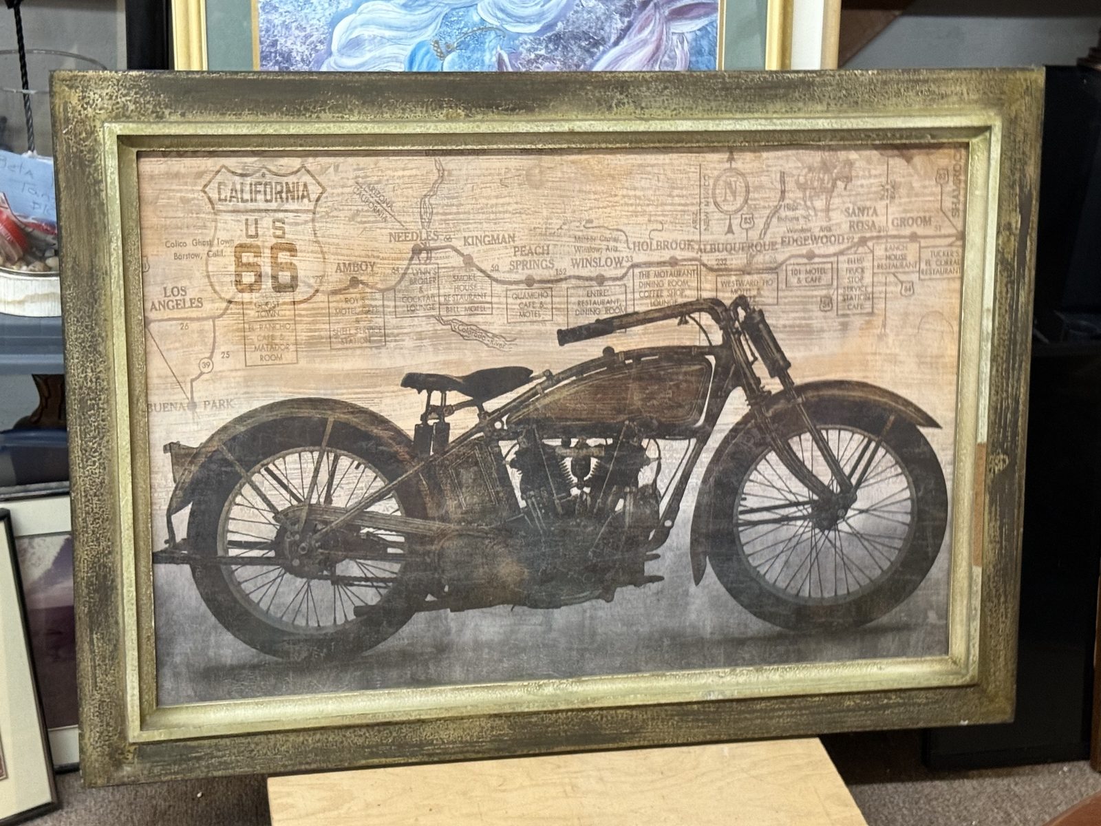 Framed vintage motorcycle print with a Route 66 map.