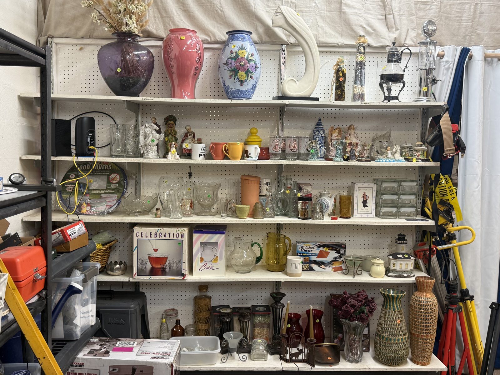 A wall of vases, glassware, figurines, and housewares at Biggar-N-Better.